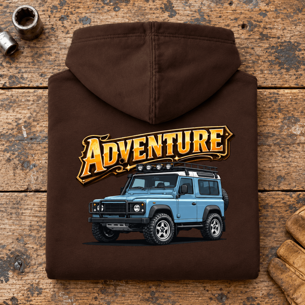 Folded hot chocolate Adventure hoodie back on a workshop bench — car-hd-0002
