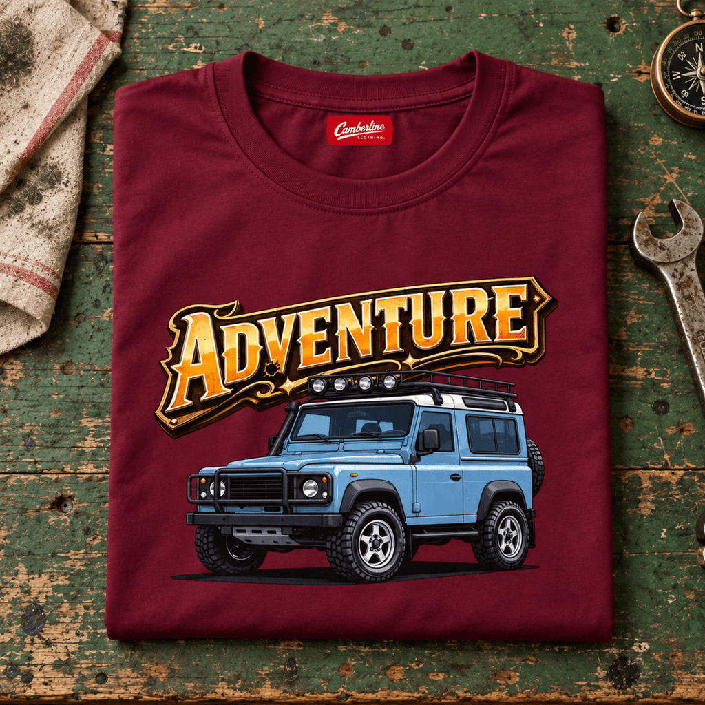 Folded burgundy adventure off road 4x4 T-shirt, front print on a worn workshop bench — car-ts-0002