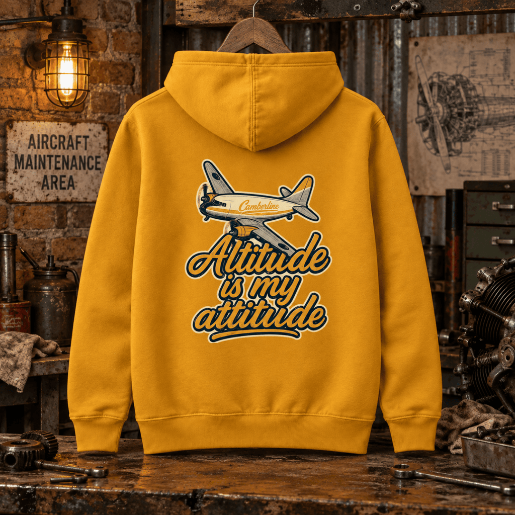 Mustard Altitude Is My Attitude propeller aircraft graphic hoodie in a gritty vintage aviation workshop