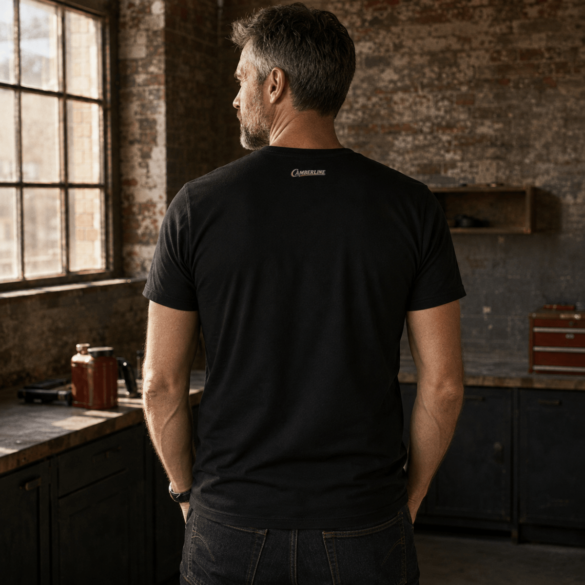 Back view of model wearing the black Camberline T-shirt with nape print