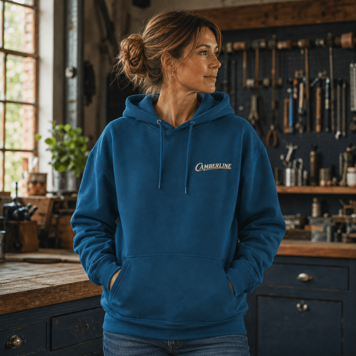 Front view of model wearing the sapphire blue Camberline hoodie with chest logo