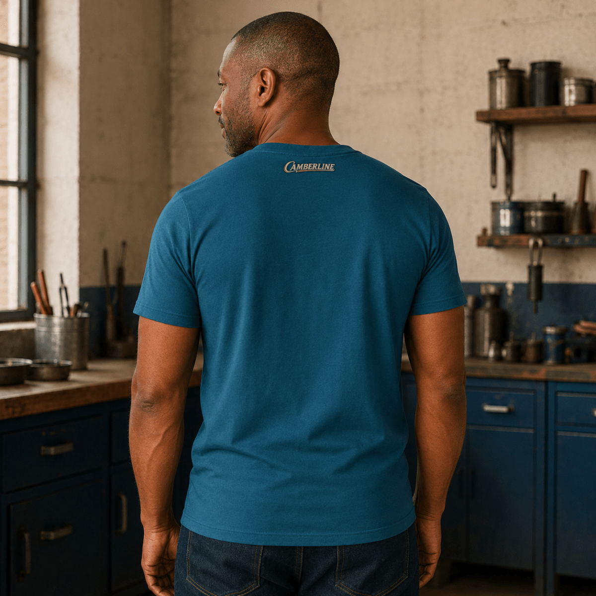 Back view of model wearing the sapphire blue Camberline T-shirt with nape print