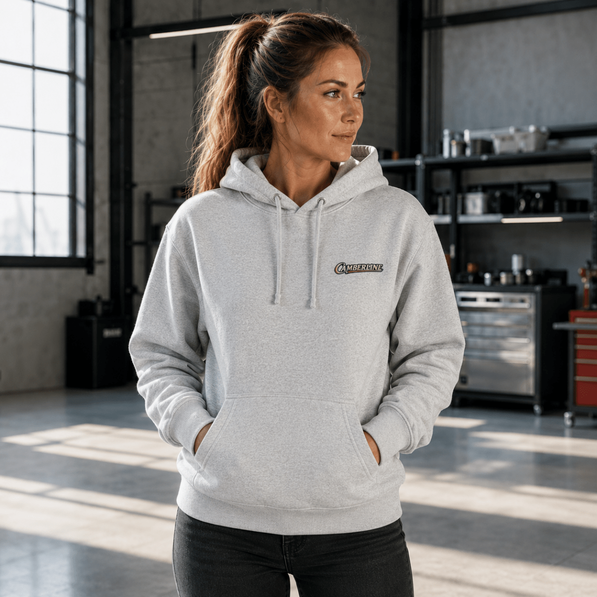 Front view of model wearing the sport grey Camberline hoodie with chest logo