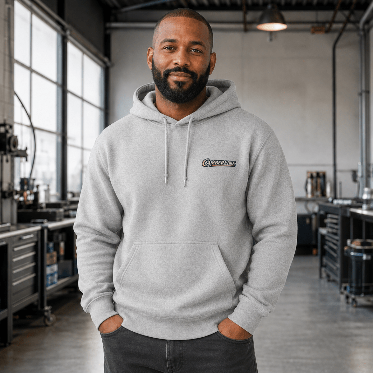 Front view of model wearing the sport grey Camberline hoodie with chest logo