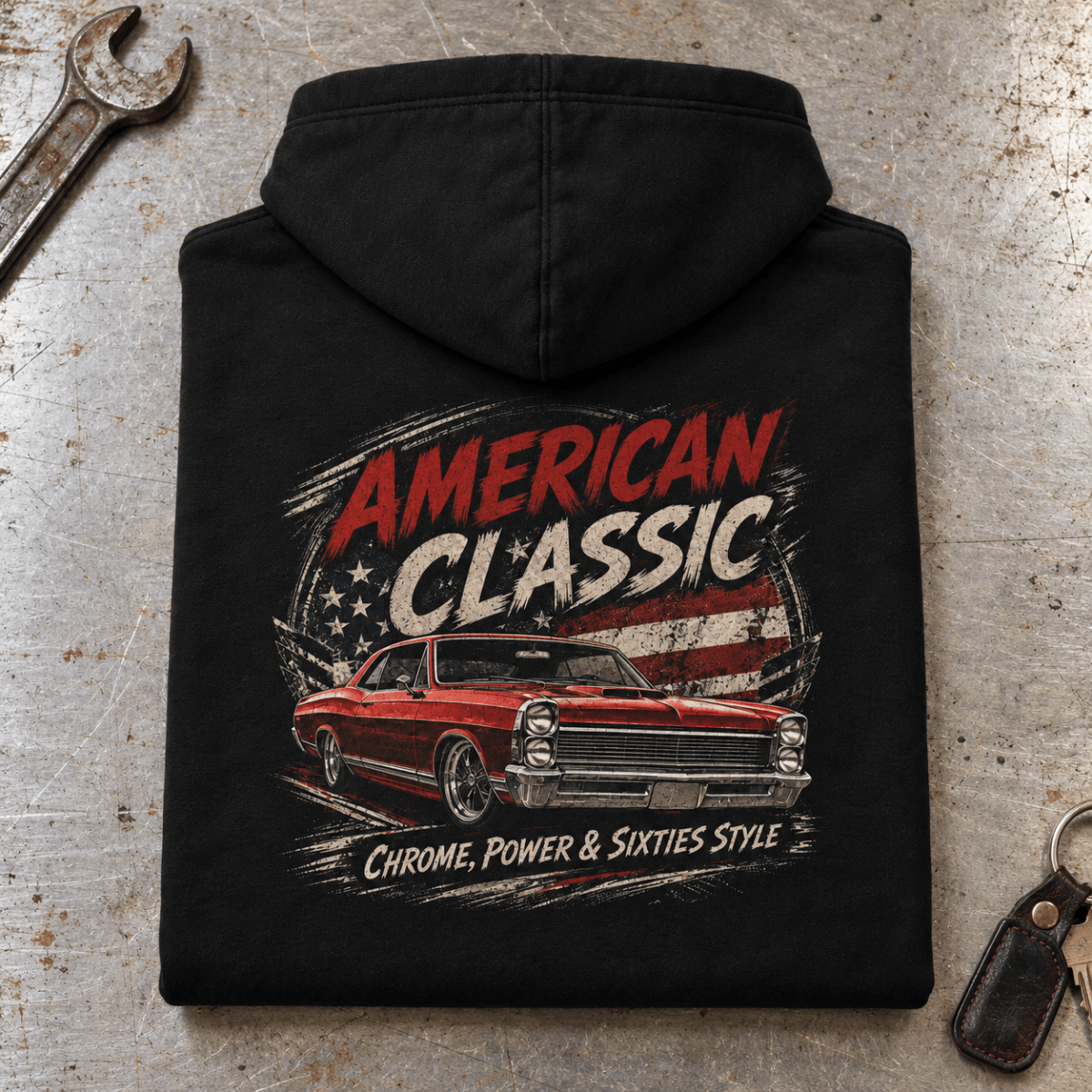 Camberline American Classic 1960s Red Muscle Coupe Graphic Hoodie in black, folded back view on a workshop bench with the full graphic visible