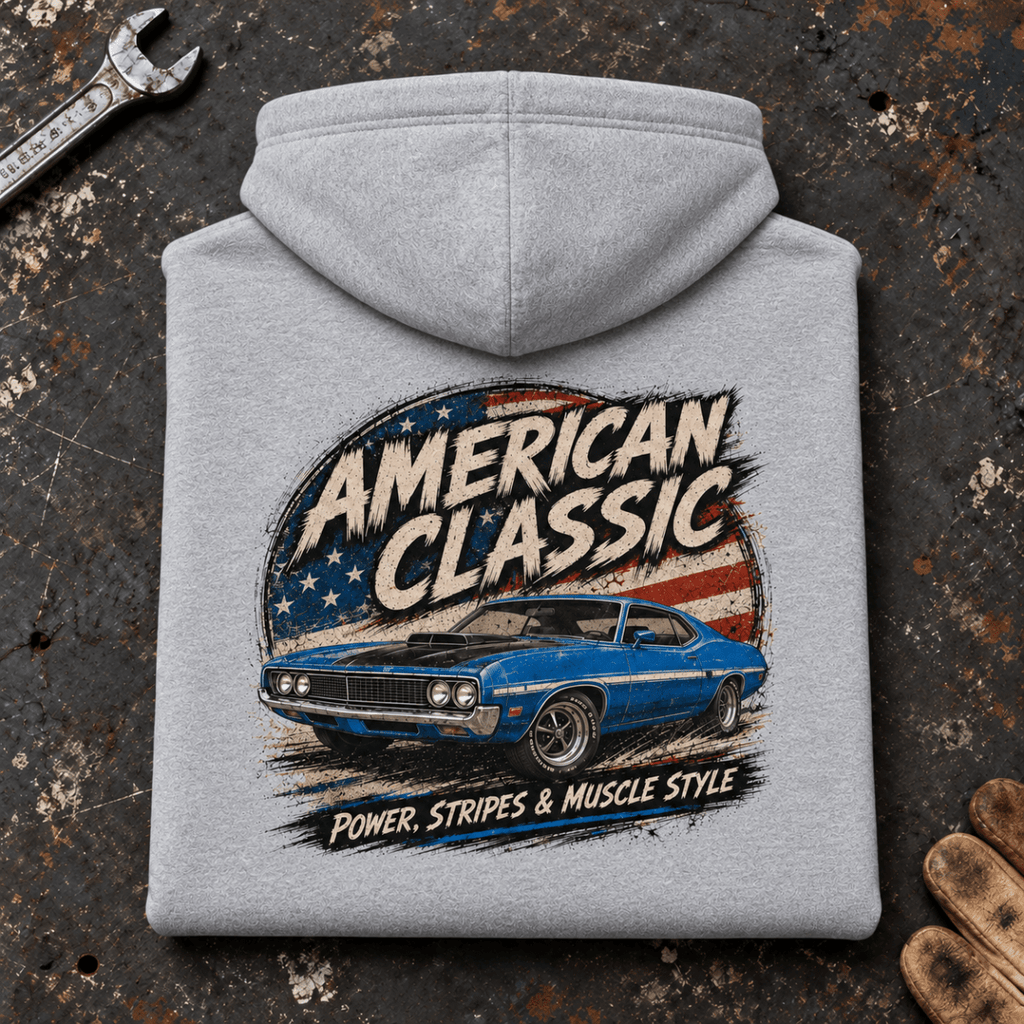 Camberline American Classic 1970s Blue Muscle Coupe Graphic Hoodie in sport grey, folded back view on a workshop bench with the full graphic visible