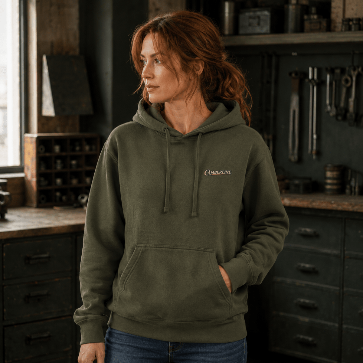 Front view of model wearing the military green Camberline hoodie with chest logo