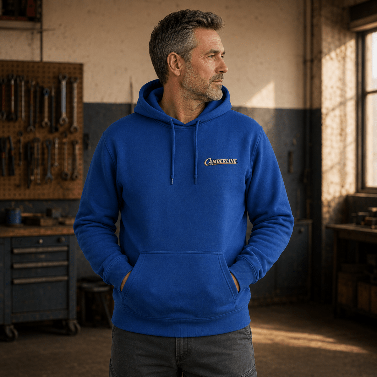 Front view of model wearing the royal blue Camberline hoodie with chest logo