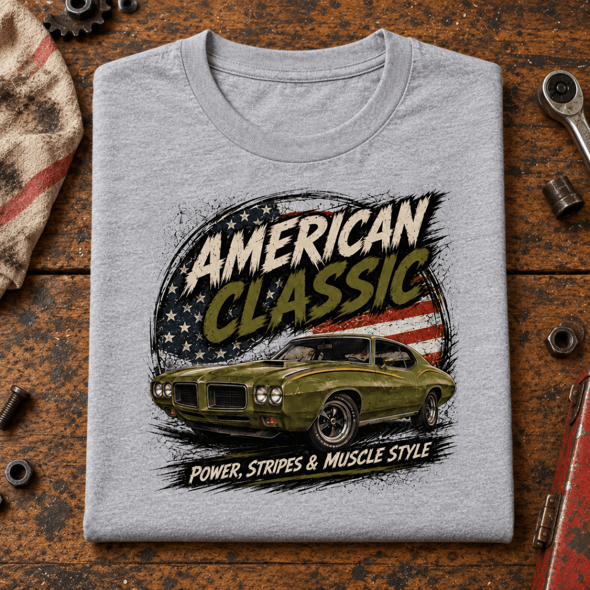 American Classic Stripes & Muscle Coupe Graphic T-Shirt – Sport Grey, folded front hero on a worn automotive workbench – car-ts-0151