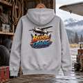 Bush Strip Legend grey aviation hoodie in mountain airstrip equipment shed