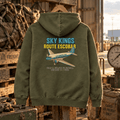 Military green Sky Kings Route Escobar hoodie in an old air-freight depot