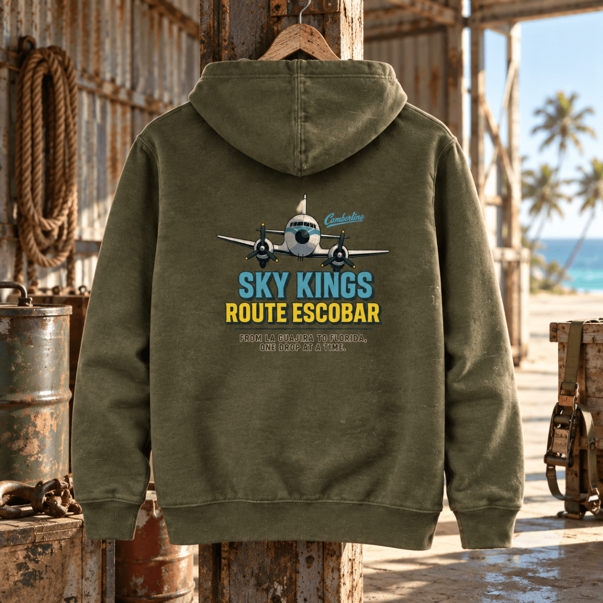 Military green Sky Kings Route Escobar hoodie in a coastal cargo-strip hangar