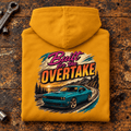 Muscle Car Graphic Hoodie – Built for the Overtake Green, folded back main hero on a worn automotive workbench – car-hd-0022