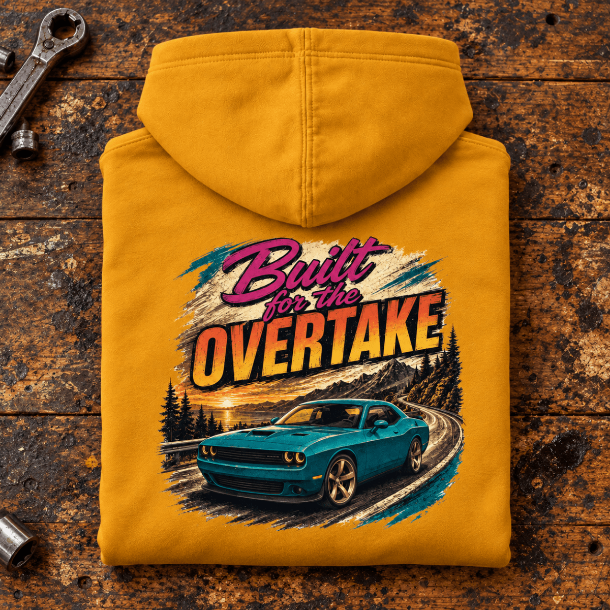 Muscle Car Graphic Hoodie – Built for the Overtake Green, folded back main hero on a worn automotive workbench – car-hd-0022