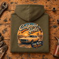 Camberline california gold classic muscle car combat green hoodie, folded rear view on a workshop bench with the complete graphic visible.