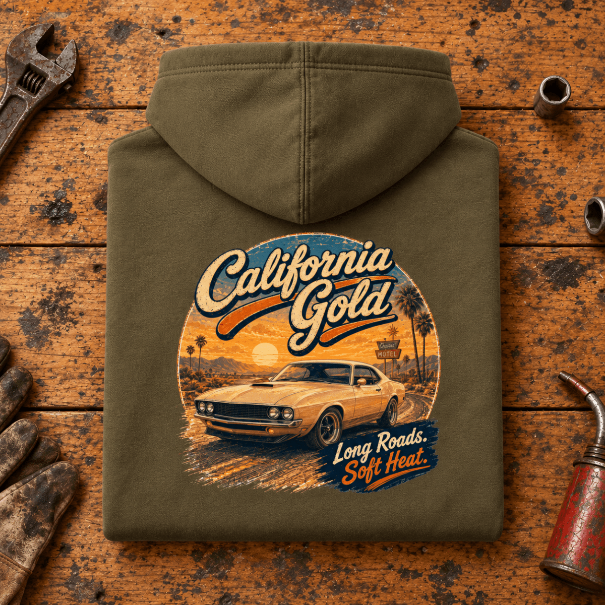 Camberline california gold classic muscle car combat green hoodie, folded rear view on a workshop bench with the complete graphic visible.