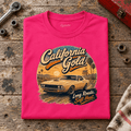 Camberline california gold classic muscle car hot pink T-shirt, folded front view on a workshop bench with the complete graphic visible.
