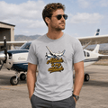 Man wearing a t-shirt with an airplane graphic and 'Altitude is my attitude' text, standing in front of a small airplane.