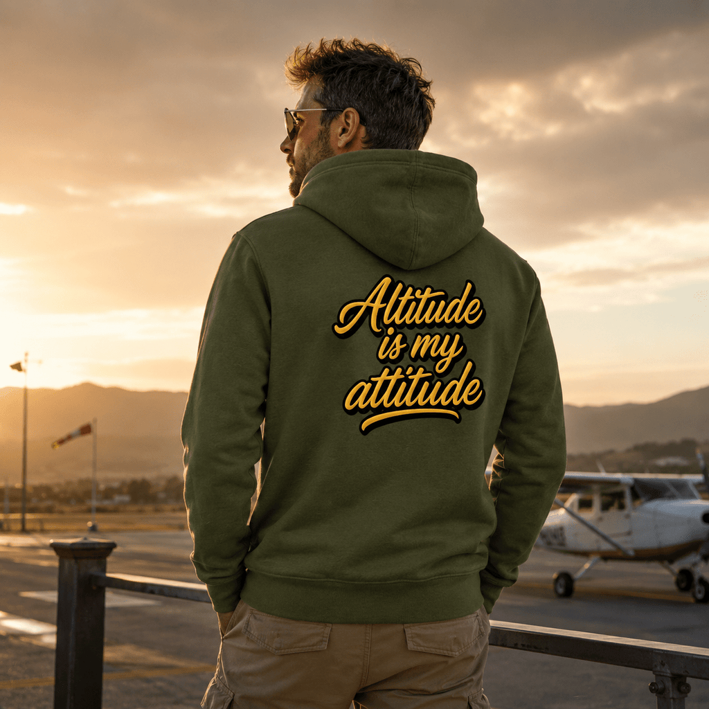 Man wearing a hoodie with 'Altitude is my attitude' text at an airport during sunset.