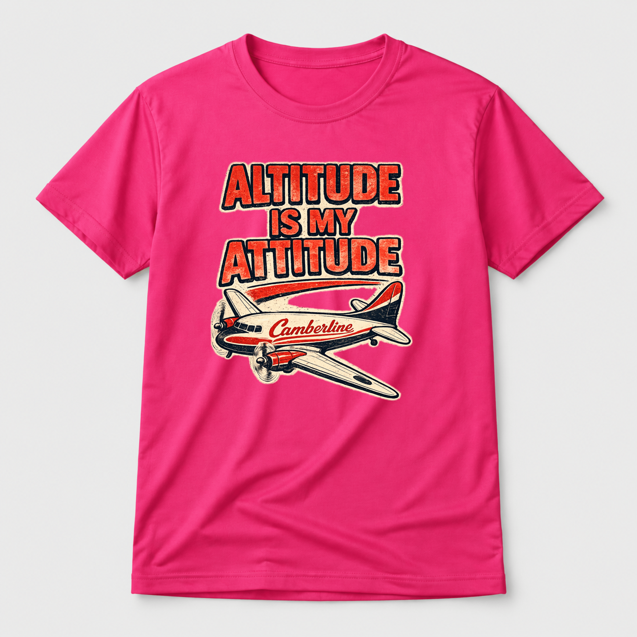 Pink t-shirt with airplane graphic and text 'Altitude is my attitude' on a white background