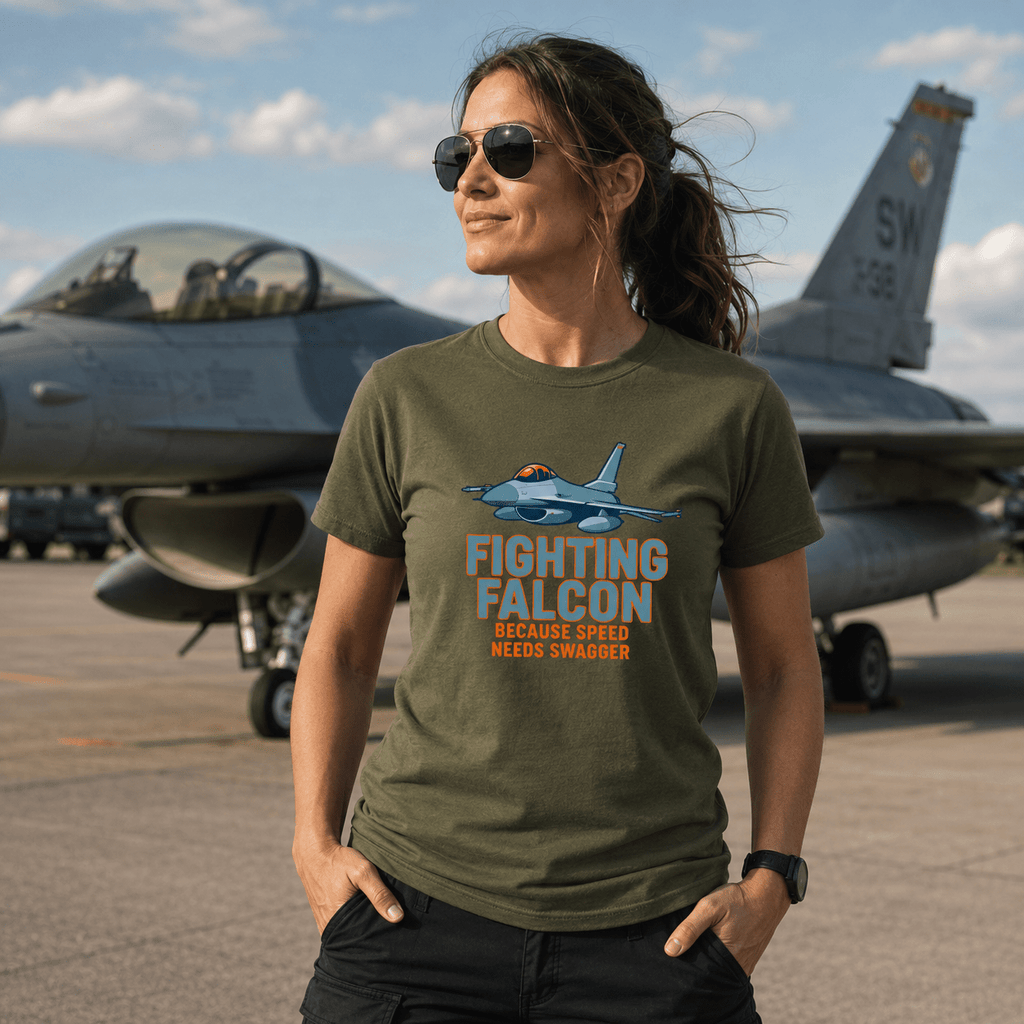 Lady outdoors wearing a military green Camberline t-shirt featuring a fighting falcon jet graphic.