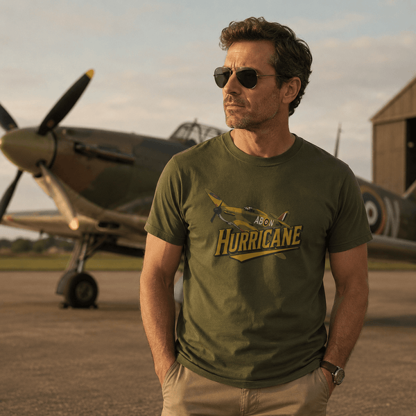 Man wearing a green t-shirt with 'Hurricane' design in front of a vintage airplane.