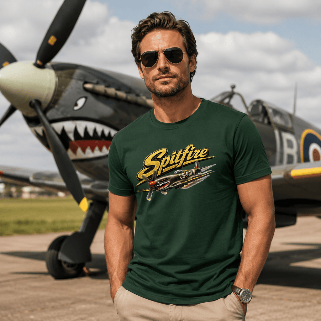 Man wearing a green 'Spitfire' t-shirt in front of a vintage airplane.