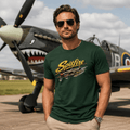 Man wearing a green 'Spitfire' t-shirt in front of a vintage airplane.