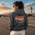 Person wearing a hoodie with an airplane design at an airport