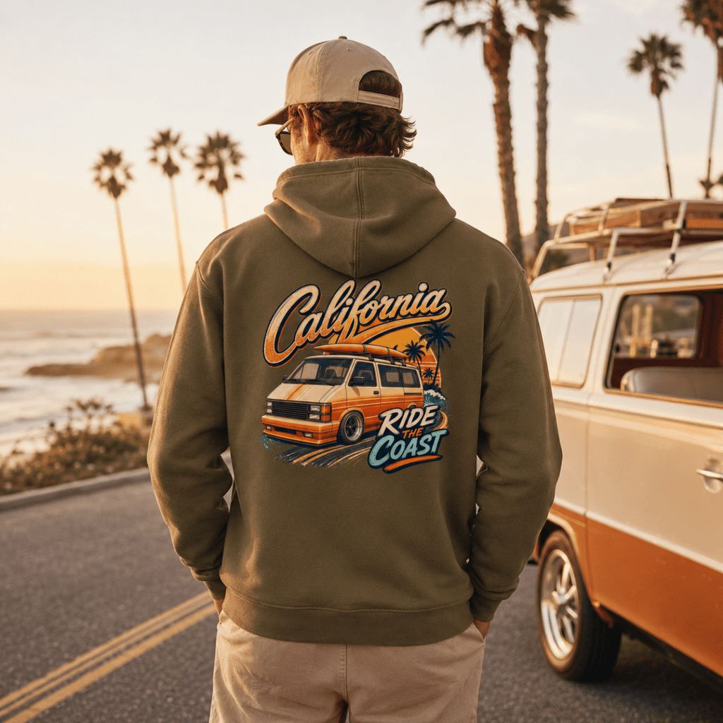 Model wearing Camberline olive van life hoodie showing California Ride the Coast orange retro van and palm tree sunset graphic on back