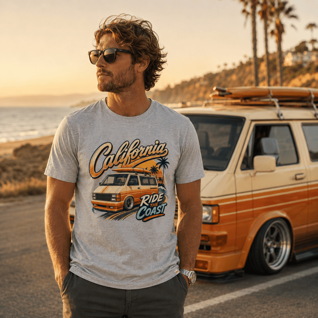 Model wearing Camberline grey marl van life t-shirt showing California Ride the Coast orange retro van and palm tree sunset graphic on chest