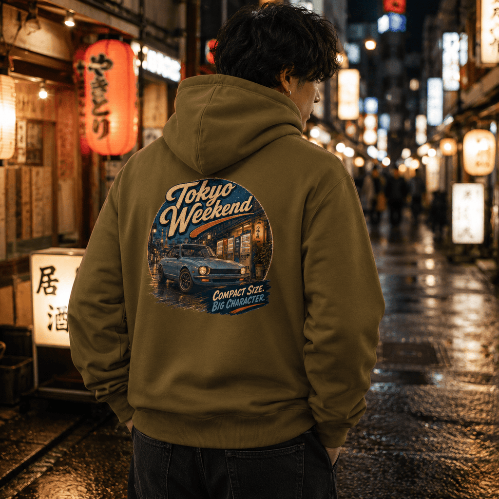 Model wearing the Camberline Cars Tokyo Weekend Classic Compact Car Hoodie – Khaki, styled in a car culture setting