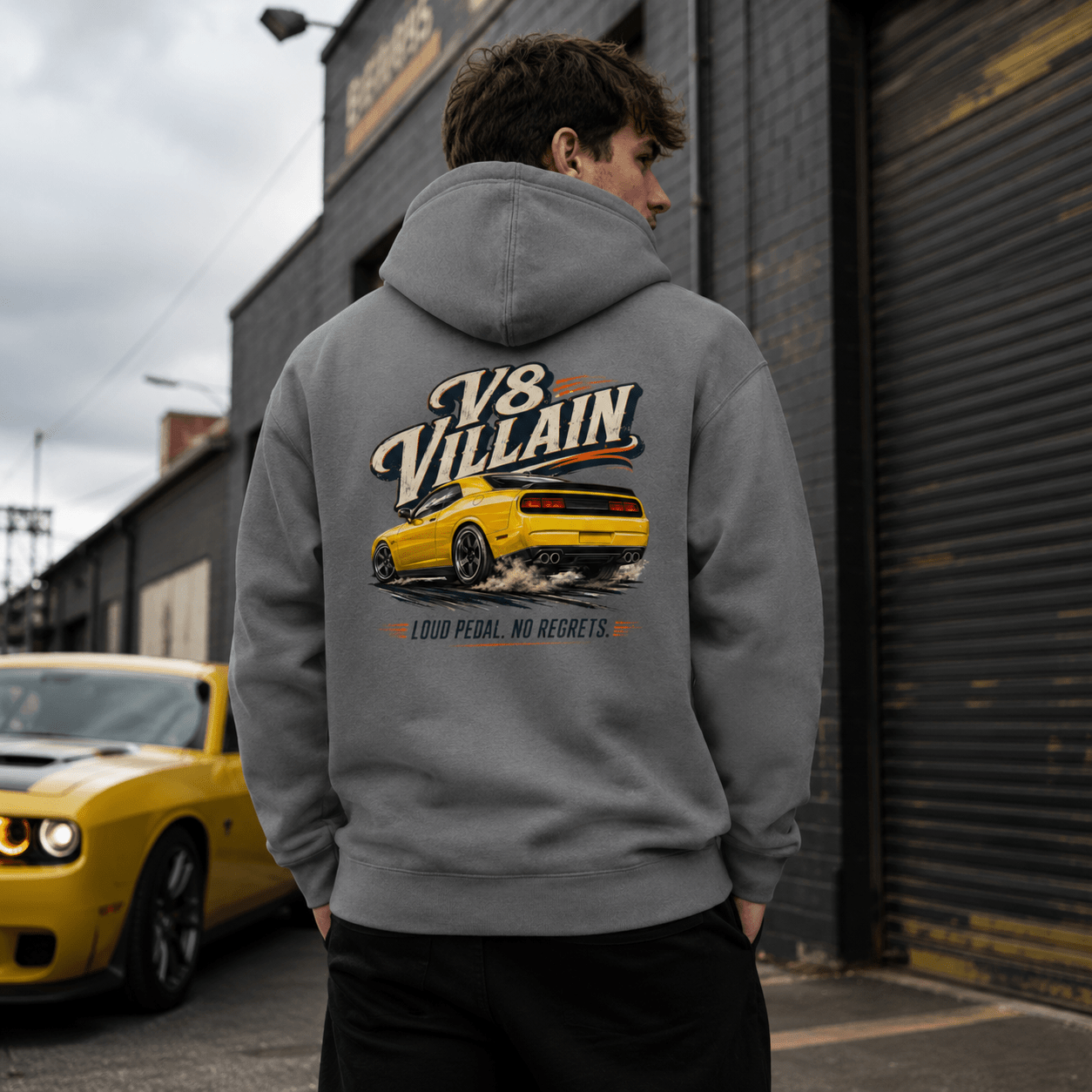 Model wearing the Camberline Cars V8 Villain Muscle Car Hoodie – Storm Grey, styled in a car culture setting