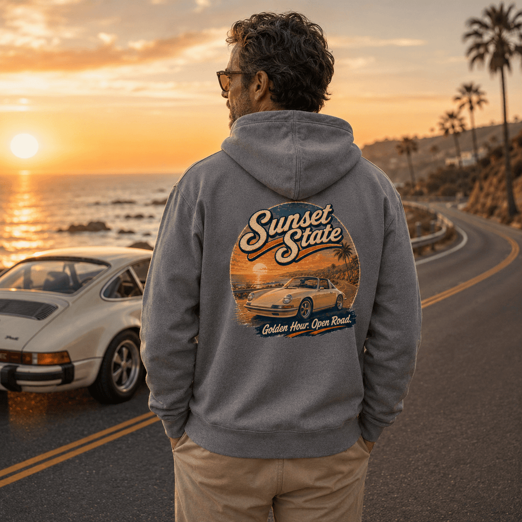 Model wearing the Camberline Cars Sunset State Classic Targa Hoodie – Heather Grey, styled in a car culture setting