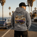Model wearing the Camberline Cars West Coast Drive Lowrider Hoodie – Heather Grey, showing the automotive graphic in a car culture setting