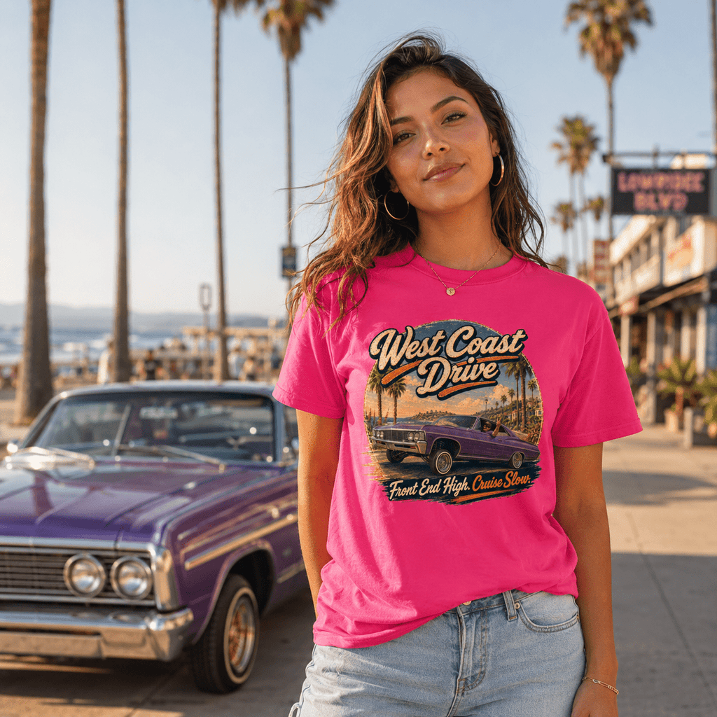 Model wearing the Camberline Cars West Coast Drive Lowrider T-Shirt – Hot Pink, showing the automotive graphic in a car culture setting