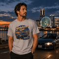 Model wearing the Camberline Cars Yokohama Run Hot Hatch T-Shirt – Sport Grey, showing the automotive graphic in a car culture setting