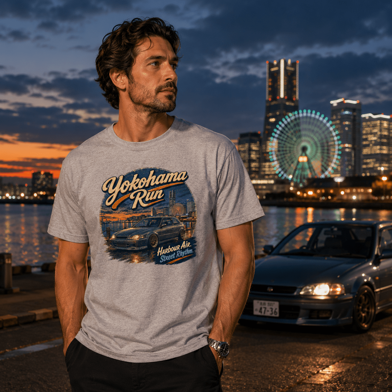 Model wearing the Camberline Cars Yokohama Run Hot Hatch T-Shirt – Sport Grey, showing the automotive graphic in a car culture setting
