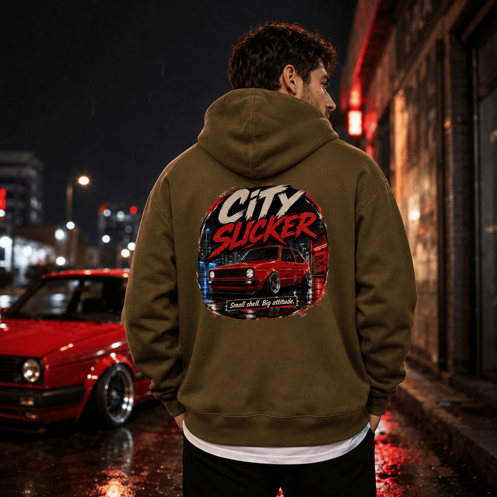 Model wearing Camberline Cars City Slicker Small Shell Big Attitude Stance Hatchback Hoodie in Combat Green