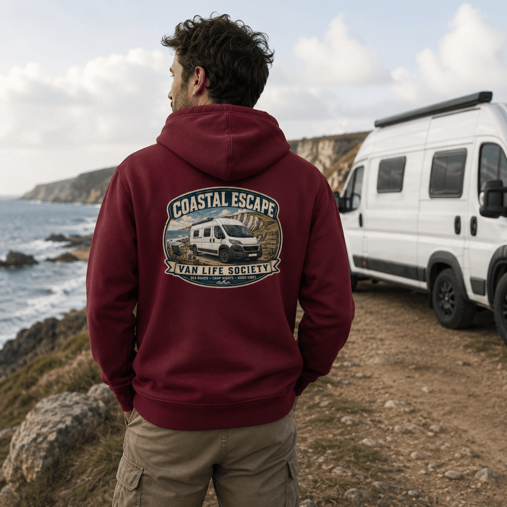 Model wearing Camberline burgundy van life hoodie showing Coastal Escape Van Life Society clifftop campervan badge on back