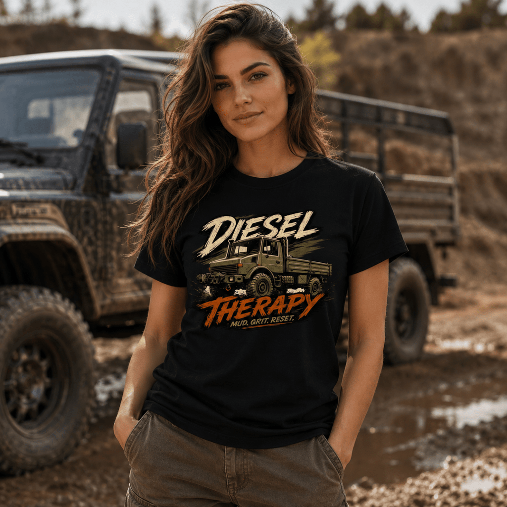Woman wearing a black t-shirt with 'Diesel Therapy' graphic in front of off-road vehicles.