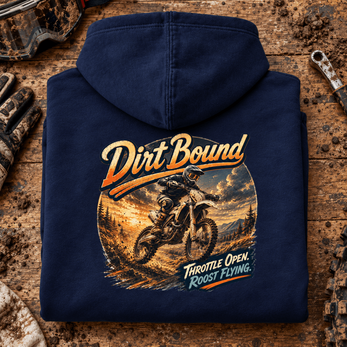 Camberline Dirt Bound enduro navy hoodie back print on a muddy paddock bench