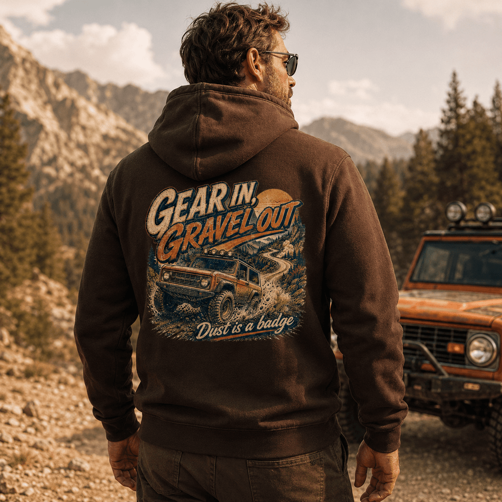 Model wearing Camberline Cars Gear In Gravel Out Dust Is A Badge Off Road 4X4 Hoodie in Hot Chocolate