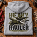 Heavy Hauler Transport Aircraft hoodie in Sport Grey (Heather Grey), folded on a workshop bench, showing the back print