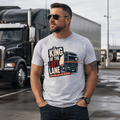 Man wearing a Grey t-shirt featuring a distressed graphic of a black and red European lorry with the text King of the Left Lane and Slow climb Heavy load Big respect.