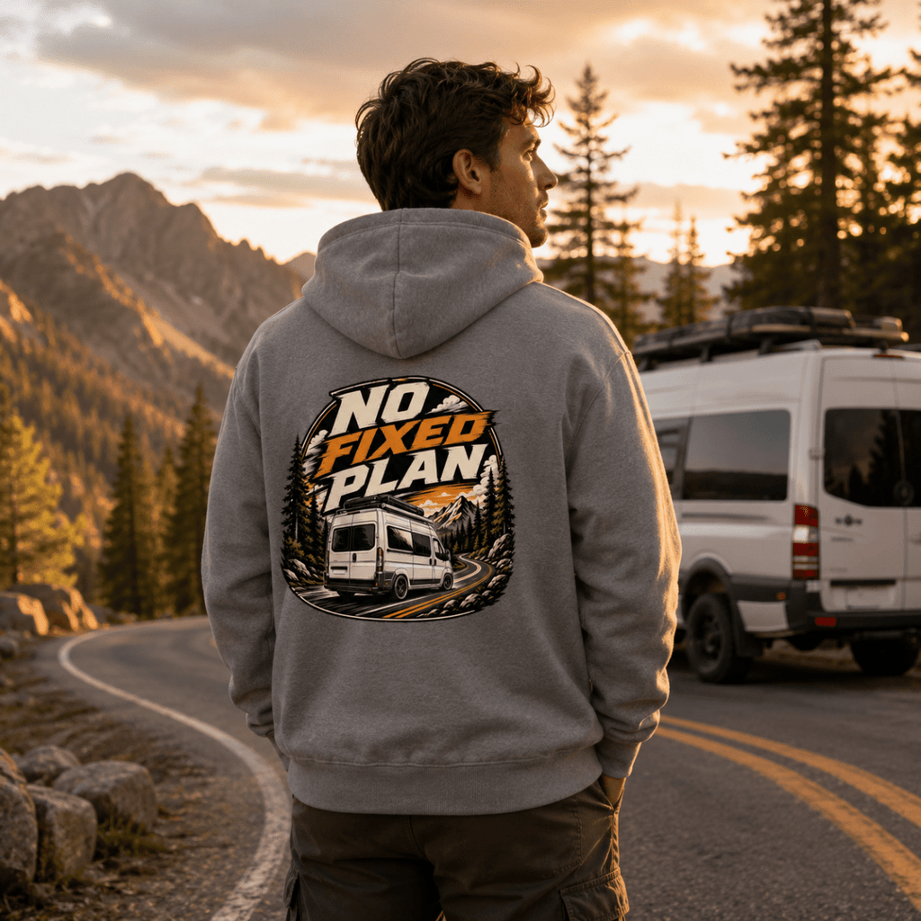 Model wearing Camberline grey van life hoodie showing No Fixed Plan circular badge with van on pine mountain road on back