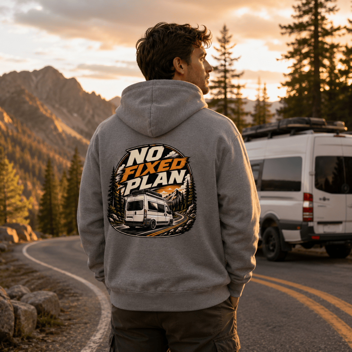 Model wearing Camberline grey van life hoodie showing No Fixed Plan circular badge with van on pine mountain road on back