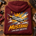 P-51 Mustang Fighter hoodie in Burgundy, folded on a workshop bench, showing the back print