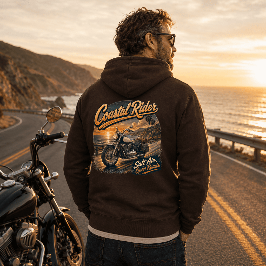 Model wearing the Camberline Riders Coastal Rider Motorcycle Hoodie – Hot Chocolate, showing the Riders back graphic in a motorcycle-inspired setting