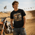 Model wearing the Camberline Riders Gate Drop Motocross Dirt Bike T-Shirt – Black, showing the Riders front graphic in a motorcycle-inspired setting